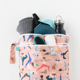 Bumkins Wet/Dry Bag: Yoga Pals holds a hairbrush, towel, water bottle, and clothes on a white background.