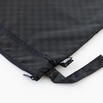 Close-up of Bumkins Wet/Dry Bag: Rich Black, featuring zippered compartments and a side handle, on a white background.