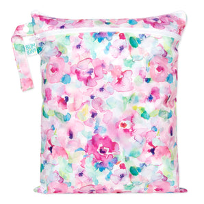 The Bumkins Wet/Dry Bag: Watercolor features pink, blue, and green florals on waterproof fabric with a zipper and handle.