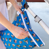 A person unzips a Bumkins Wet/Dry Bag: Mickey & Friends Forever attached to a stroller handle.