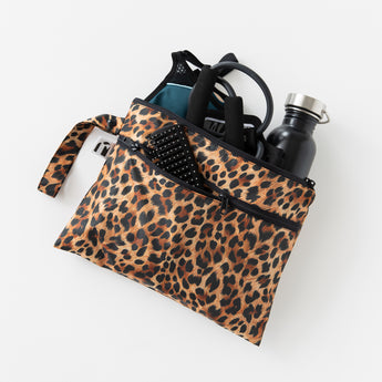 Roamio by Bumkins Wet/Dry Clutch: Leopard holds gym essentials on a white background.