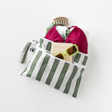 Roamio by Bumkins Wet/Dry Clutch: Clubhouse Stripe with swimwear, sunglasses, hair clip & passport on a white background.