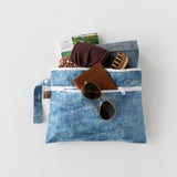 A bag from Bumkins On-The-Go Mealtime 6-Piece Set: Denim + Blue holds travel essentials on a white background.