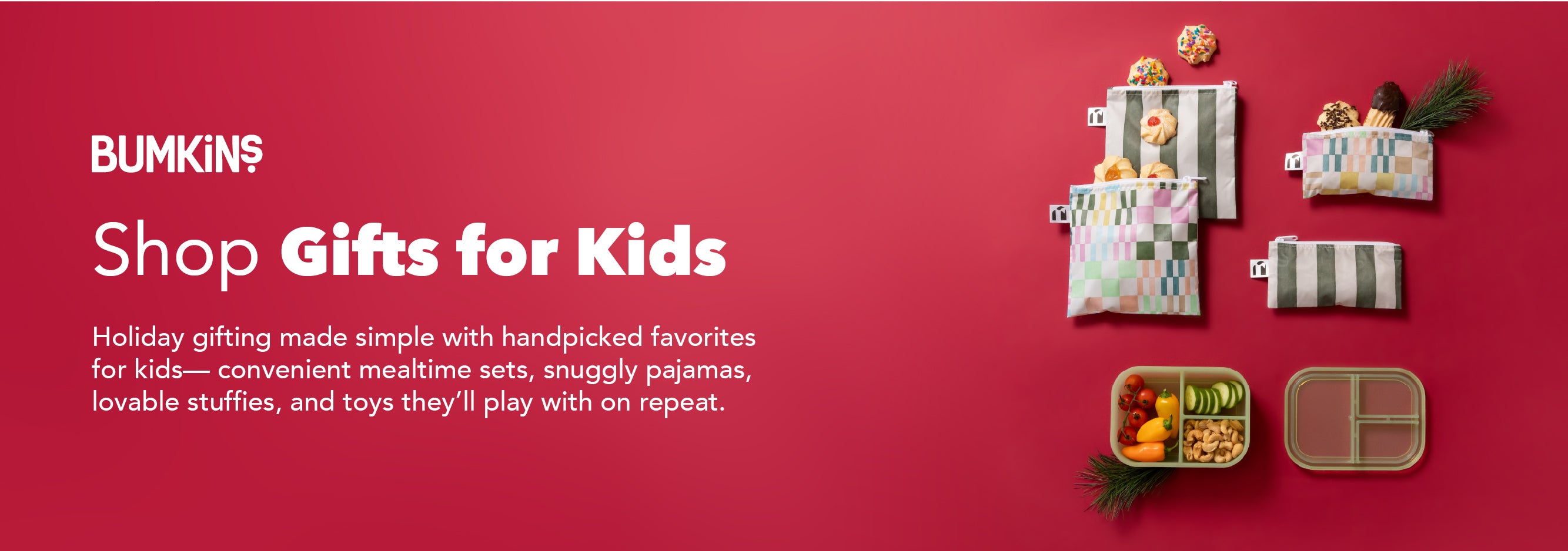 Colorful kids’ gifts, including pouches, toys, and a lunchbox, arranged on a red background with pine sprigs.