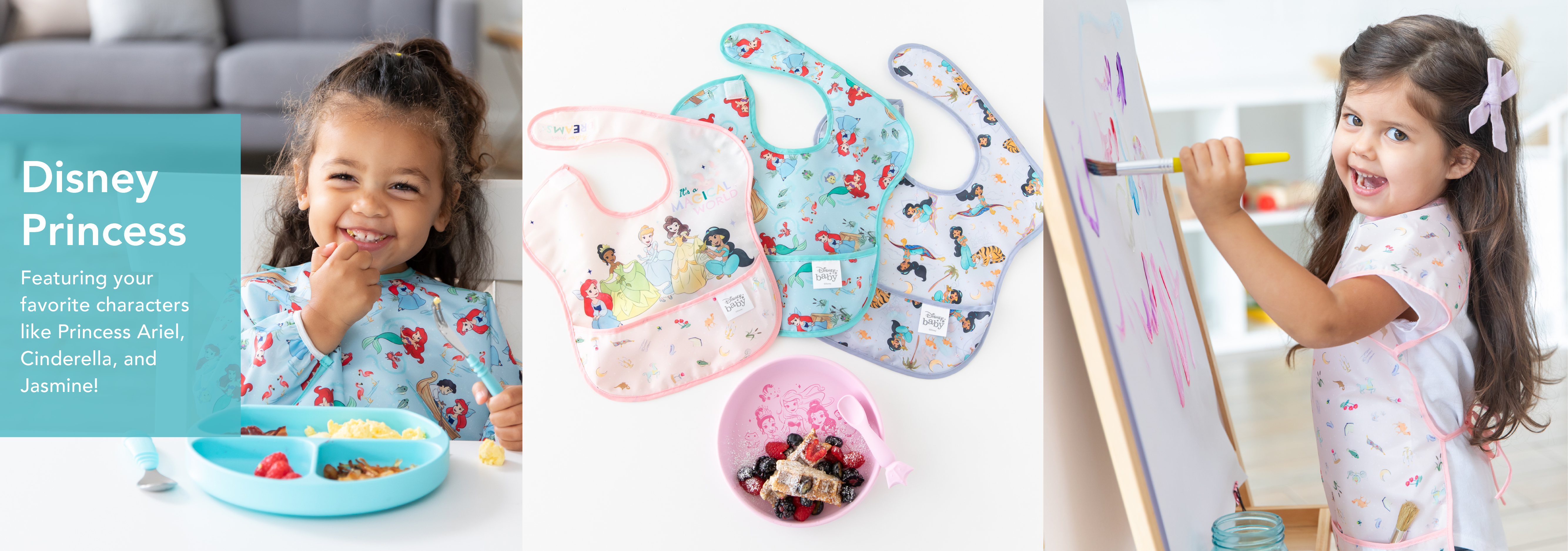 A young girl smiles while eating from a blue plate with noodles and vegetables. Next to her are three Disney Princess-themed bibs featuring Ariel, Cinderella, and Jasmine. Another girl paints on an easel wearing a similar themed shirt.