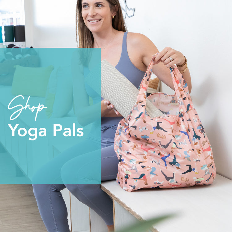 A woman in athletic wear holds a pink bag with a yoga pattern, pulling out a yoga mat. The text Shop Yoga Pals is overlaid on a teal rectangle on the left. She sits on a bench in a bright, modern room.