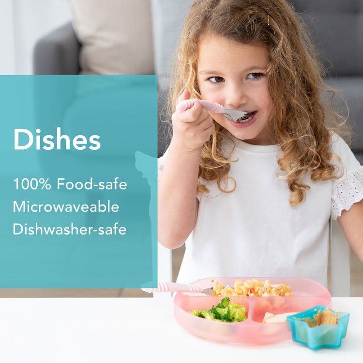 Young girl with curly hair eating from a divided pink plate. Shes using a fork, with broccoli, pasta, and other food on the plate. Text reads: Dishes, 100% Food-safe, Microwaveable, Dishwasher-safe.