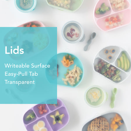 A variety of colorful, divided plates containing different foods, such as vegetables, pasta, and waffles, are arranged on a surface. A blue text box reads: Lids Writeable Surface Easy-Pull Tab Transparent.
