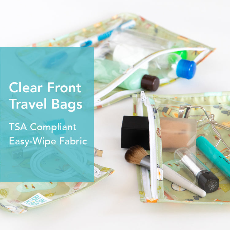 Three clear-front travel bags on a surface display travel-sized toiletries like bottles, a toothbrush, and makeup brushes. A blue text box highlights the bags as TSA Compliant with Easy-Wipe Fabric.