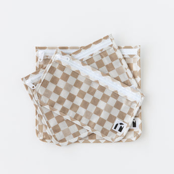 Roamio by Bumkins Clear Travel Bag 3 Pack: Sand Check is stacked on a white background.