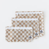 Roamio by Bumkins Clear Travel Bag 3 Pack: Sand Check lays neatly overlapped on a white background.