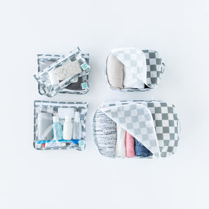 The Bumkins Packing Cube 2 Pack + Clear Travel Bag 3 Pack Set in Charcoal Check keeps travel essentials organized and tidy.