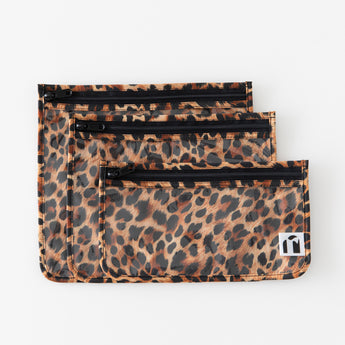 Roamio by Bumkins Clear Travel Bag 3 Pack: Leopard lays overlapped on a white background.