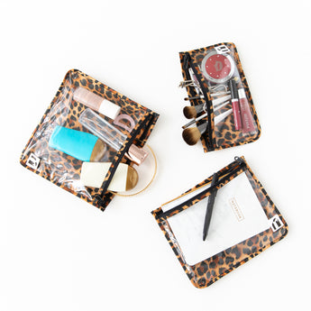 Bags from Roamio by Bumkins The Commuter Essential 4-Piece Set: Leopard hold makeup and toiletries on a white background.