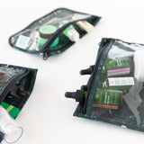 Bumkins Clear Travel Bag 3 Pack: Starry Cactus with skincare products are neatly arranged on a white background.