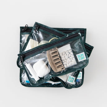 Bumkins Clear Travel Bag 3 Pack: Starry Cactus are stacked on a white background, filled with toiletries, hair accessories and mints.
