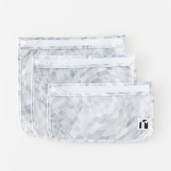Roamio by Bumkins Clear Travel Bag 3 Pack: Disco Check lays stacked on a white background.