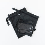 Bumkins Clear Travel Bag 3 Pack: Rich Black lie on top of other bags with a similar print on a white background.