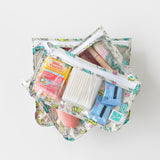 Bumkins Clear Travel Bag 3-Pack: Cacti lays stacked on a white background with toiletries & vitamin C packets inside.