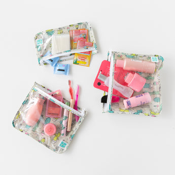 Bumkins Clear Travel Bag 3-Pack: Cacti lays flat on a white background, holding toiletries, makeup, and travel accessories.