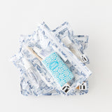 Roamio by Bumkins Clear Travel Bag 3 Pack: Shells lays stacked on a white background, filled with toiletries.