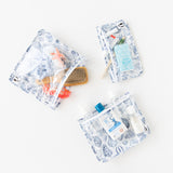 Bags from Roamio by Bumkins The Commuter Essential 4-Piece Set: Shells hold toiletries and hair accessories on a white background.