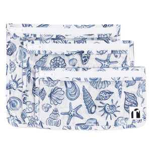 Roamio by Bumkins Clear Travel Bag 3 Pack: Shells includes 3 TSA-compliant bags made of white waterproof fabric with a blue shell pattern.