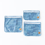 Roamio by Bumkins Clear Travel Bag 3 Pack: Crushed Denim is neatly arranged on a white background.