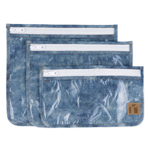 Roamio by Bumkins Clear Travel Bag 3 Pack: Crushed Denim—3 TSA-compliant waterproof pouches made of blue denim printed waterproof fabric.