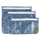 Roamio by Bumkins Clear Travel Bag 3 Pack: Crushed Denim—3 TSA-compliant waterproof pouches made of blue denim printed waterproof fabric.