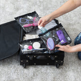 Hands pack toiletries in bags from Bumkins The Chaos Coordinator Essential 4-Piece Set: Mickey Mouse Icon Black + White in a suitcase.
