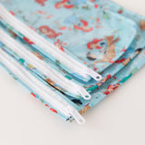 Close-up of Bumkins Clear Travel Bag 3 Pack: Disney Princess Ariel on a white background, with focus on the zipper.