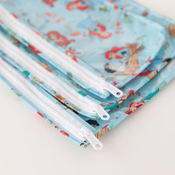 Close-up of Bumkins Clear Travel Bag 3 Pack: Disney Princess Ariel on a white background, with focus on the zipper.
