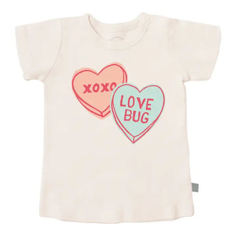 Finn and Emmas Love Bug Organic Tee features vintage-inspired heart designs, XOXO and LOVE BUG, crafted with eco-friendly dyes.
