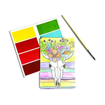 Desert Getaway DIY Watercolor Kit by OOLY: Paint a cow skull with flowers using red, yellow, and green on white canvas. Comes with a brush.