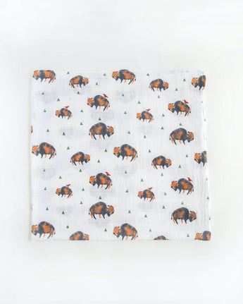 Little Unicorns Cotton Swaddle Set features white muslin with bison and green triangles, ideal for swaddling.