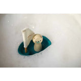 The PlanToys Sailing Boat with Polar Bear drifts through white foamy bubbles.