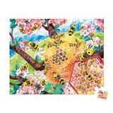 Janod Juratoys Bee Life 100 Piece Puzzle: Bees, a beehive in cherry blossoms, and lush green hills form a vibrant ecosystem.