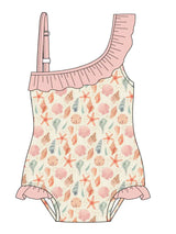 Emerson and Friends One Piece Swimsuit features a Sandy Seashells print, pink ruffle trim, and UV protective fabric.