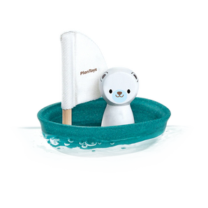 PlanToys Sailing Boat, Polar Bear: Sustainable toy sailboat with a teal base, white sail, and polar bear figure floats on water.