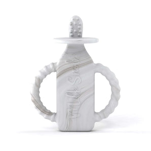 The Milk Snob Calm n Cuddle™ Cookies & Cream teether is a bottle-shaped, gray and white silicone toy with handles and texture.