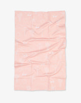Geometry Tea Towels, Pink Paradise: pink microfiber waffle towels featuring white line drawings of cacti, umbrellas, suns & palm trees.