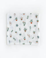 Little Unicorns Cotton Swaddle Set in Bison features a breathable white muslin cloth with a cute cactus and potted plant design.