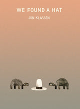 Two turtles eye a hat with a gradient brown backdrop. Text: We Found a Hat Hardcover Book by Jon Klassen, Random House.