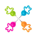 Four Lil Dimpl Keychains by Fat Brain Toy Co: star-shaped silicone bag hangers with rings in pink, green, blue, and orange.