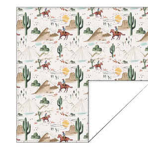 The Bamboo Swaddle, Billy by Bird & Bean features a southwestern pattern with cowboys, cacti, and mountains under a sunny sky.
