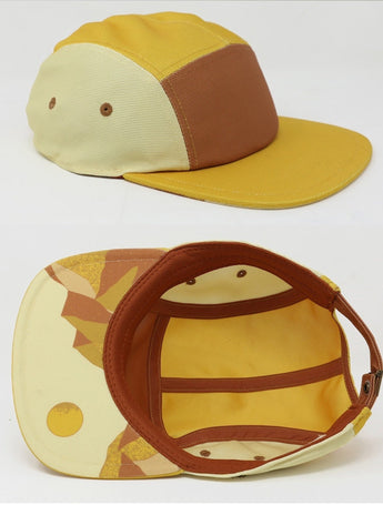 Storied Hats Lil Hat, Desert Sunset: yellow & brown cap with abstract brim patterns, adjustable strap, and quick-drying fabric.