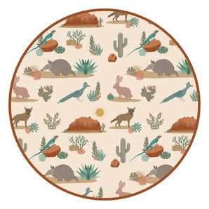 The Emerson and Friends Bamboo Blanket, Desert Friends boasts a circular pattern of armadillos, rabbits & desert flora on beige.