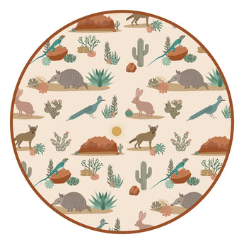 The Emerson and Friends Bamboo Blanket, Desert Friends boasts a circular pattern of armadillos, rabbits & desert flora on beige.