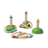 The PlanToys Meadow Ring Toss has 3 wood pegs on green bases and bright rings, enhancing fine motor skills.